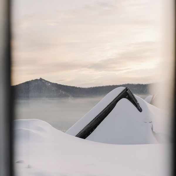 Silhouette of a person stretching against a sunrise, feeling energized.